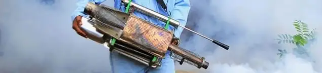 Fumigation technician using a fogger for deep pest treatment in Erie, PA